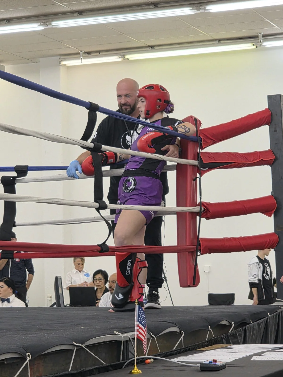 A fighter receives coaching in a ring corner.