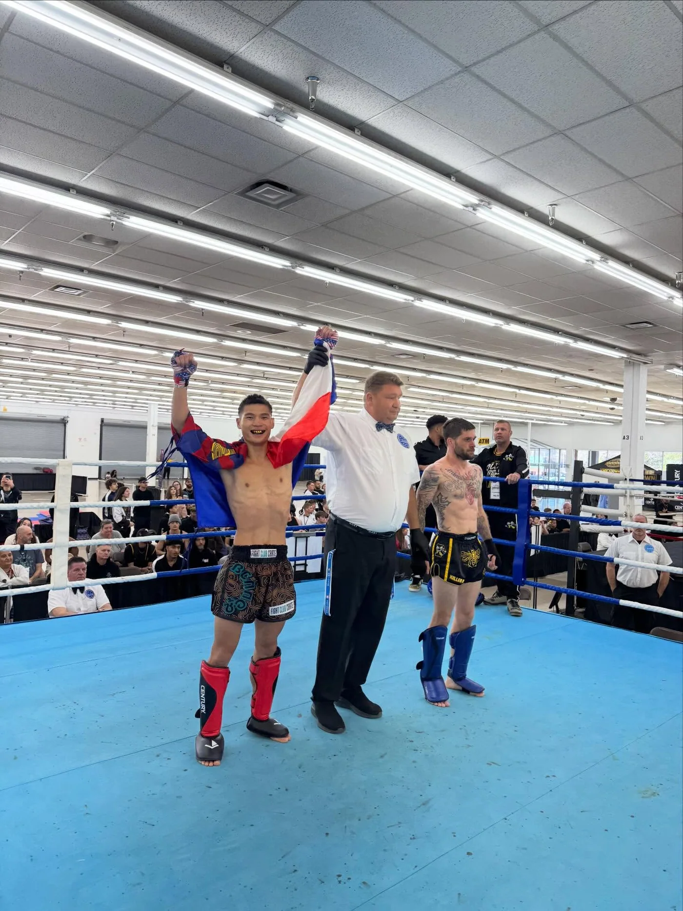 A competitor with a raised arm at the end of a bout.